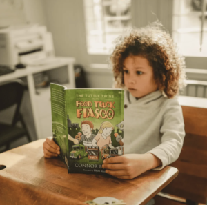Child Reading Tuttle Twins