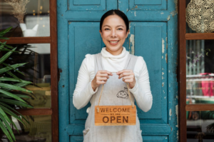 Woman Holding "We Are Open" Sign
